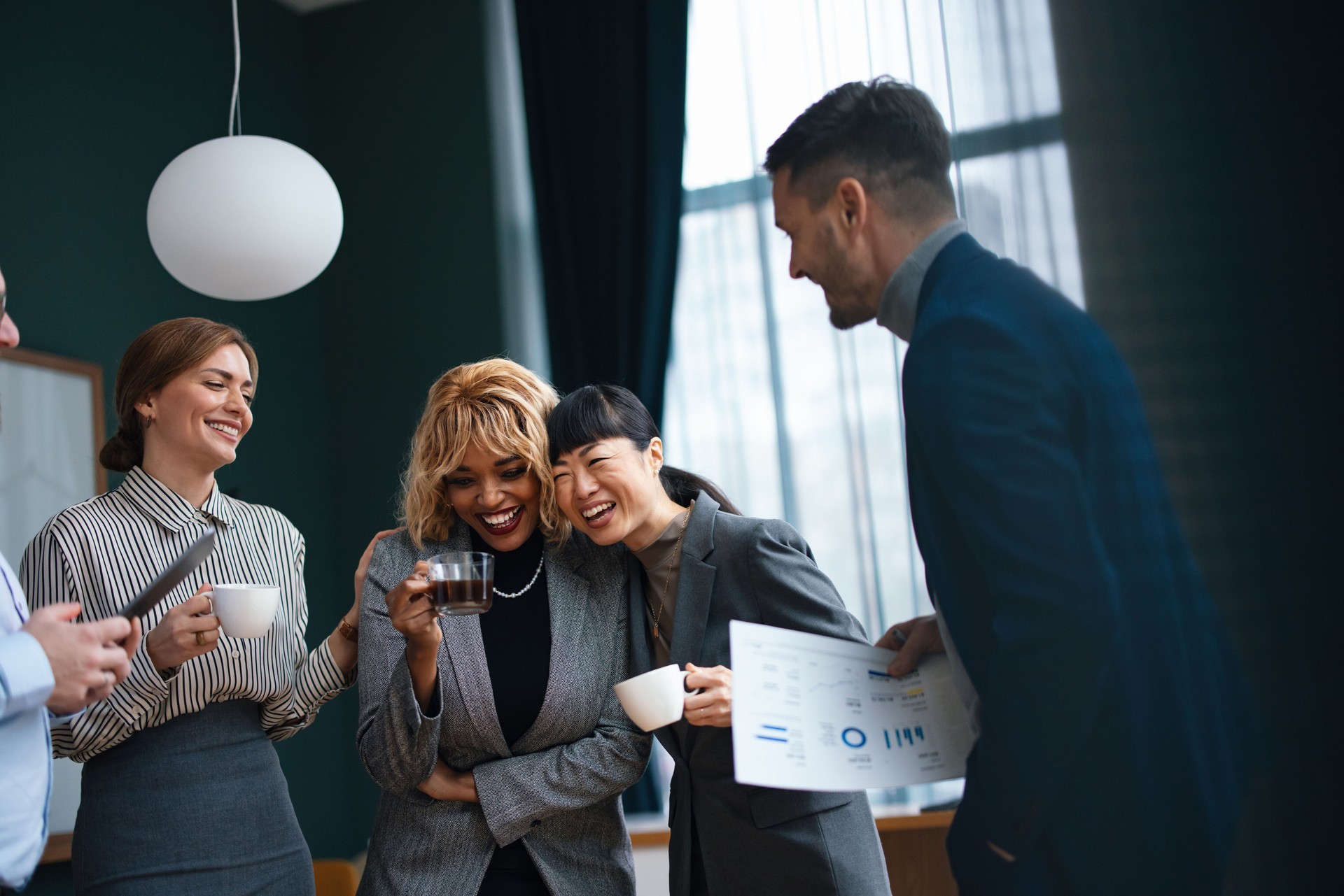 Group Of Happy Businesspeople On A Casual Meeting At Their Company